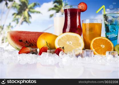 Summer drink, palm branch and Fresh tropical fruits. Summer drink with blur beach on background