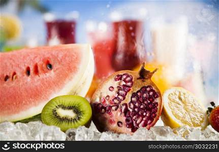 Summer drink, palm branch and Fresh tropical fruits. Summer drink with blur beach on background