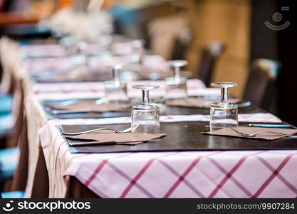 Summer empty open air restaraunt in italian city in Italy. Closeup wineglasses on the table. Summer empty open air restaraunt in Vatican city in Italy. Closeup wineglasses on the table