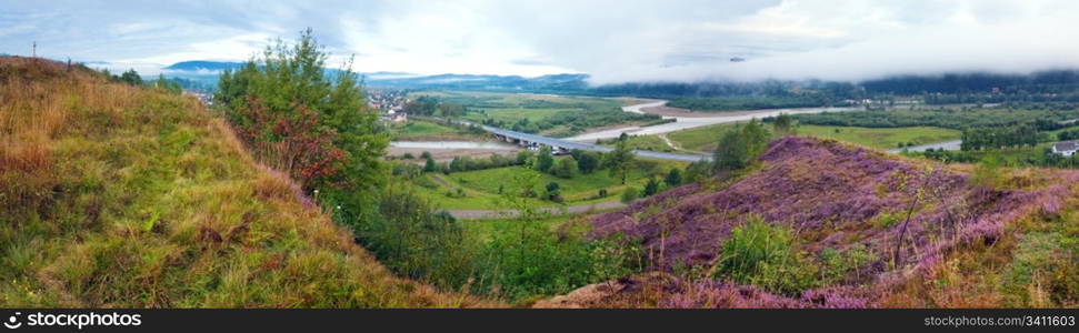 Summer evening country foothills panorama with heather flowers and wooden cross (Lviv Oblast, Ukraine) . Three shots stitch image.