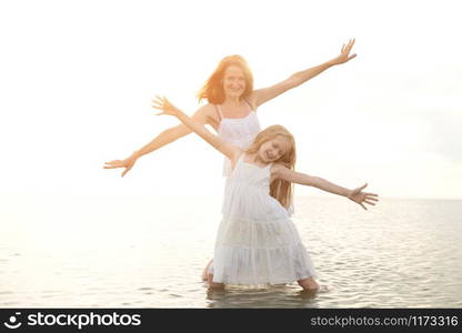 summer family lifestyle. mother with daughter at the evening sea