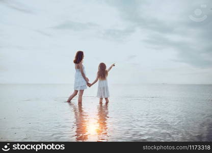 summer family lifestyle. mother with daughter at the evening sea