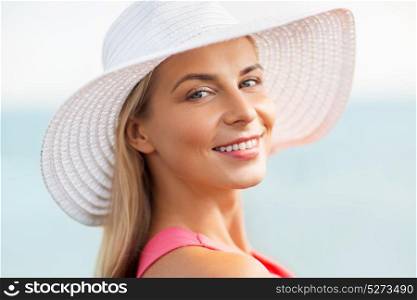 summer, fashion and people concept - portrait of beautiful smiling woman in sun hat. portrait of beautiful smiling woman in sun hat