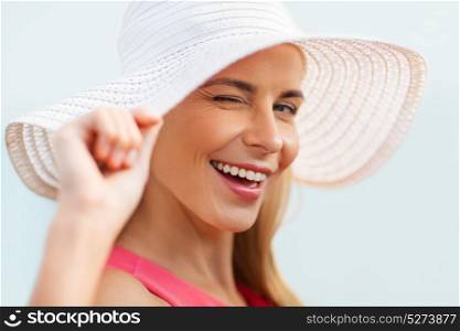 summer, fashion and people concept - portrait of beautiful smiling woman in sun hat. portrait of beautiful smiling woman in sun hat