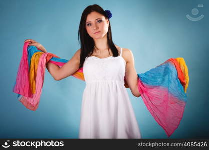 Summer fashion. Beauty young woman fashionable sensual girl with coloured shawl on blue background