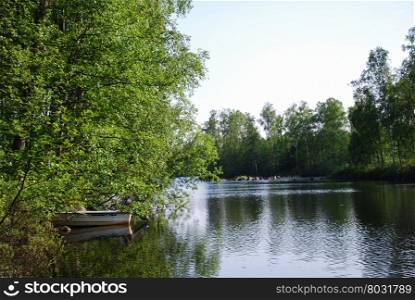 Summer feeling with a rowing boat at an idyllic swedish lake