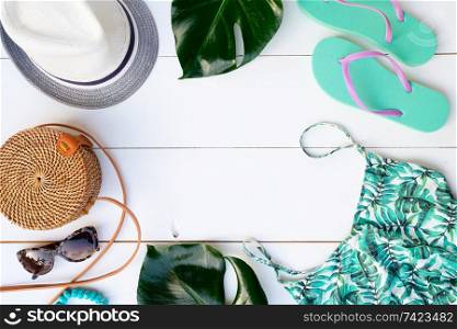 Summer flat lay frame with beach accessories pattern on white background. Summer flat lay scenery with swimsuit