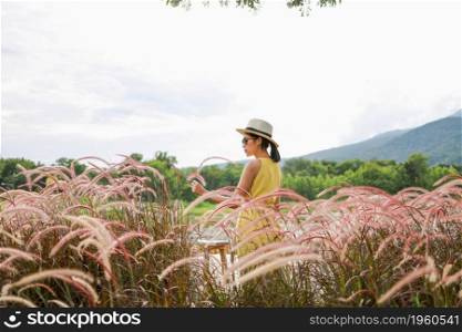 Summer Flowers Beautiful young asian woman fabulous nature waiting for summer sun on meadow vacation Asian girl Happy girl relaxing enjoys the autumn sunset