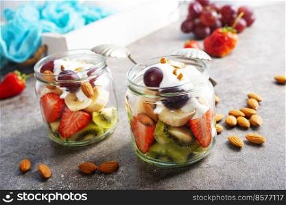 Summer fruit salad with cream and dry almonds. Summer fruit salad with white cream and almonds
