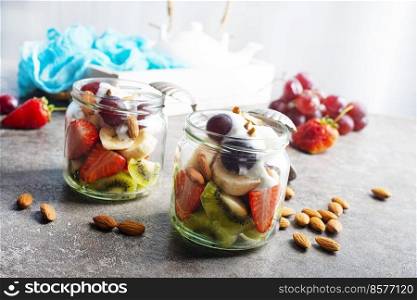 Summer fruit salad with cream and dry almonds. Summer fruit salad with white cream and almonds