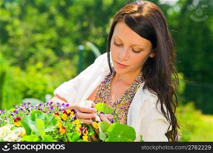 Summer garden beautiful young romantic woman with colorful flower portrait