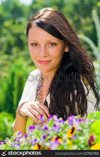 Summer garden beautiful young woman smiling flowers