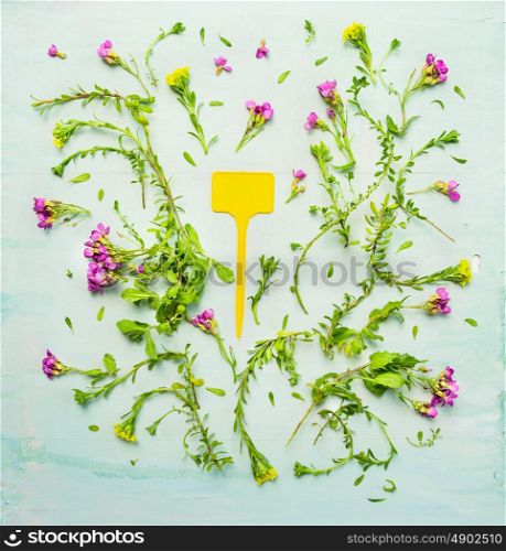 Summer garden flowers with blooming and sign on green wooden background, top view