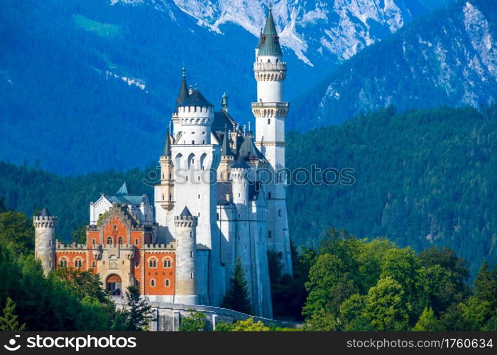 Summer Germany. Sunny morning. The mountains are covered with forests. Castle Neuschwanstein. Palace Neuschwanstein Surrounded by Wooded Mountains