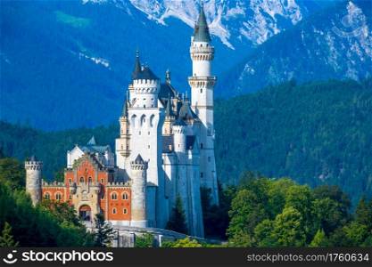 Summer Germany. Sunny morning. The mountains are covered with forests. Castle Neuschwanstein. Palace Neuschwanstein Surrounded by Wooded Mountains