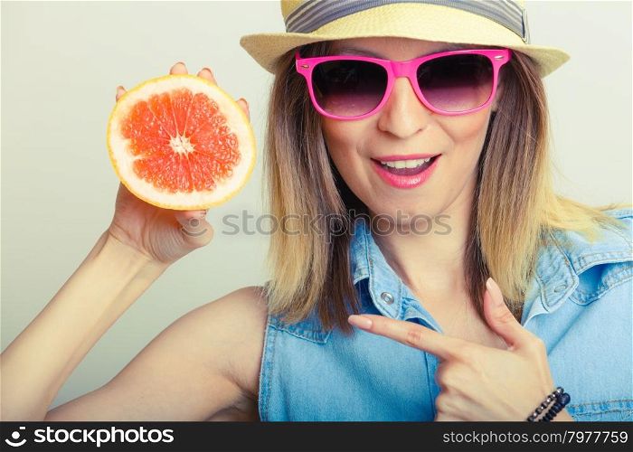 Summer girl holding grapefruit. Summer girl holding grapefruit. Happy tourist enjoyed vacation.