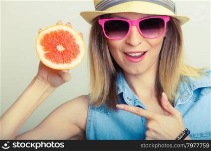 Summer girl holding grapefruit. Summer girl holding grapefruit. Happy tourist enjoyed vacation.