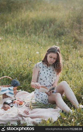 Summer - girl on a picnic in a meadow in the forest