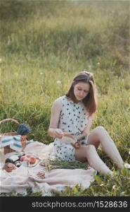Summer - girl on a picnic in a meadow in the forest