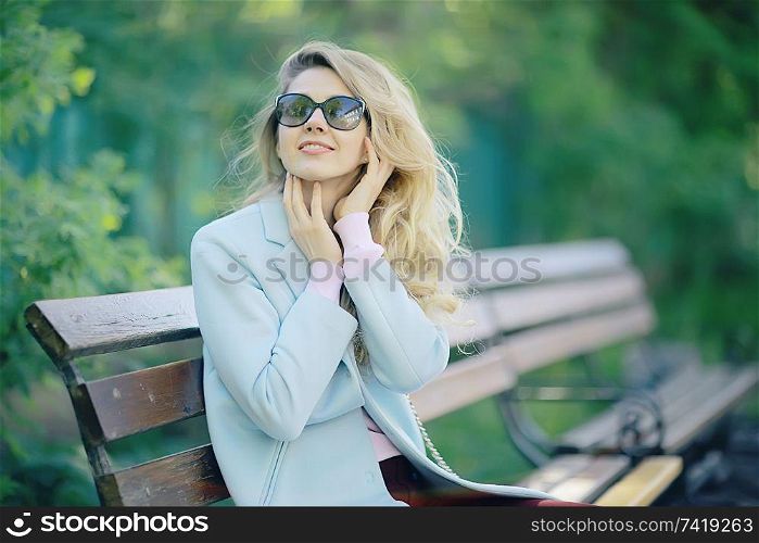 summer girl outdoor air / cheerful adult girl model on a summer walk in the city park, happiness, pleasure freedom