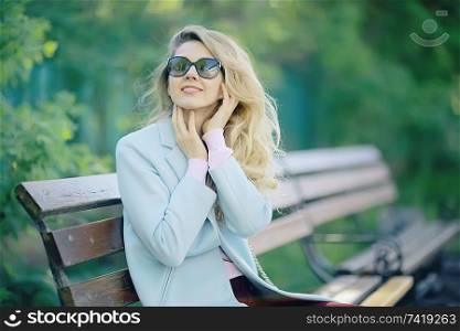 summer girl outdoor air / cheerful adult girl model on a summer walk in the city park, happiness, pleasure freedom