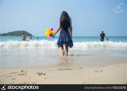 Summer girl play travel in holiday on tropical summer beach. Cheerful Joyful seaside with cute kid vacation on sunny day.