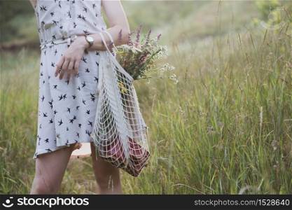 Summer - girl with a bouquet walks through the meadow. summer mood and inspiration