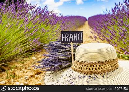 Summer hat and board with sign France against fresh lavender field. Attraction trip for french vacation in Provence.. Summer hat at lavender field. Holidays in France.