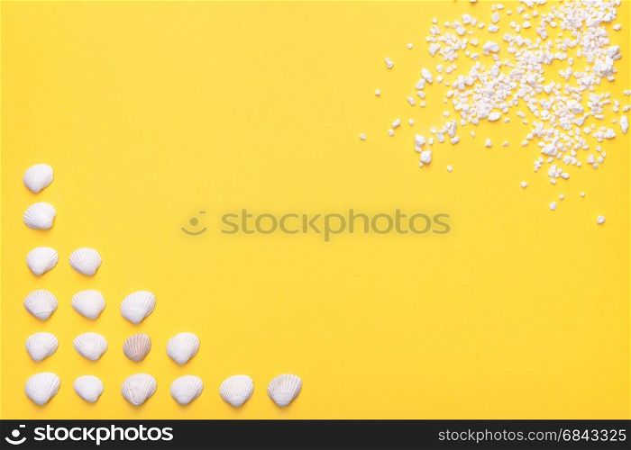 Summer holiday background with shells and sand in white. Copy space. Top view