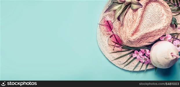 Summer holiday banner. Beach accessories : straw hat, palm leaves, pink sun glasses, flowers and coconut cocktail on blue turquoise background, top view. Tropical vacation travel concept