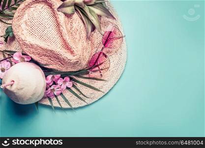 Summer holiday . Beach accessories : straw hat, palm leaves, pink sun glasses, flowers and coconut cocktail on blue turquoise background, top view. Tropical vacation travel concept