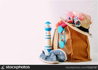Summer holiday travel concept.Hipster Beach bag with items for a day at the seaside on white background
