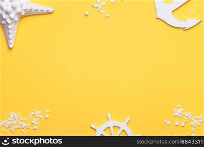 Summer holiday vacation background with starfish, anchor and rudder in white. Copy space. Top view