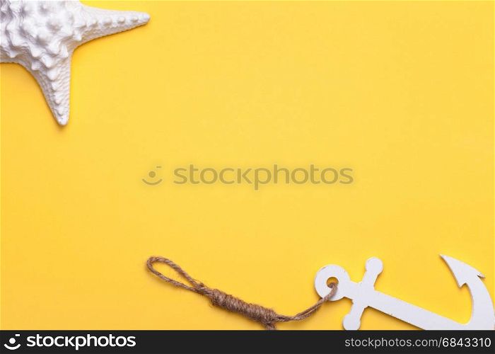 Summer holiday vacation background with starfish and anchor in white. Copy space. Top view