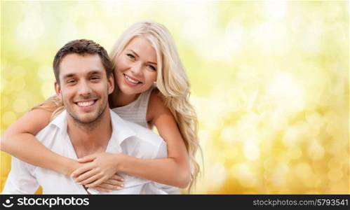 summer holiday, vacation, dating and love concept - happy couple having fun over yellow lights background