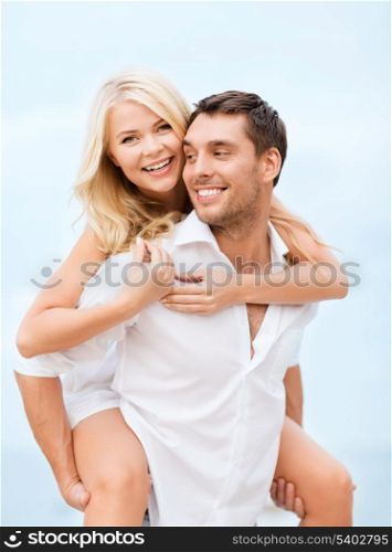 summer holiday, vacation, dating and tourism concept - happy couple having fun on the beach