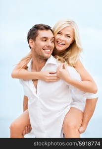 summer holiday, vacation, dating and tourism concept - happy couple having fun on the beach