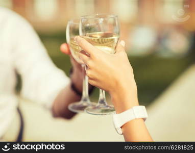 summer holidays and dating concept - couple drinking wine in cafe in the city