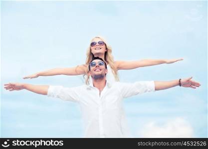 summer holidays and dating concept - couple holding hands up at sea side. couple holding hands up at sea side