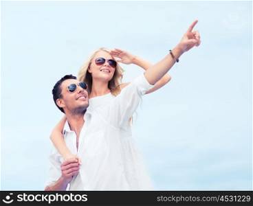 summer holidays and dating concept - couple in shades at sea side. couple in shades at sea side