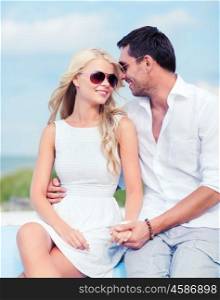 summer holidays and dating concept - couple in shades at seaside. couple in shades at seaside