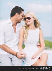 summer holidays and dating concept - couple in shades at seaside. couple in shades at seaside