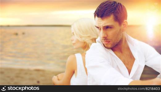 summer holidays and dating concept - couple sitting at sea side. couple at sea side