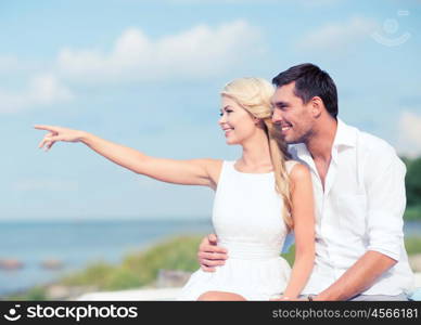 summer holidays and dating concept - couple sitting at sea side. couple sitting at sea side