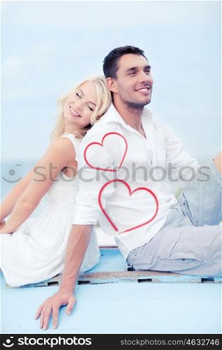 summer holidays and dating concept - couple sitting on boat at sea side. couple sitting on boat at sea side