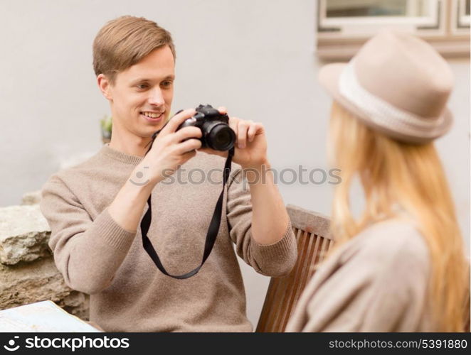 summer holidays and dating concept - couple taking photo picture at cafe in the city