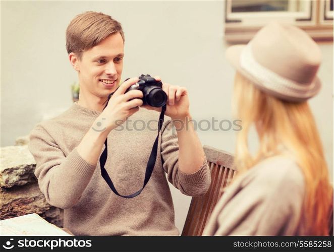 summer holidays and dating concept - couple taking photo picture at cafe in the city