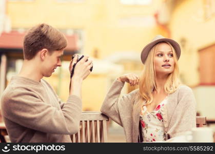 summer holidays and dating concept - couple taking photo picture at cafe in the city