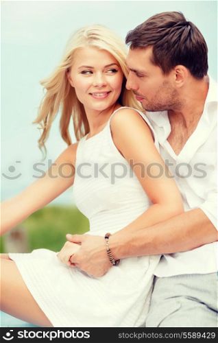 summer holidays and dating concept - smiling couple at sea side