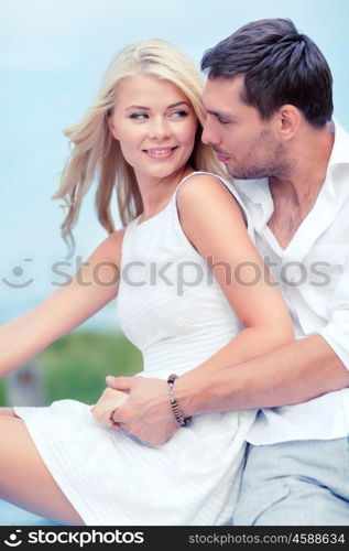 summer holidays and dating concept - smiling couple at sea side. smiling couple at sea side